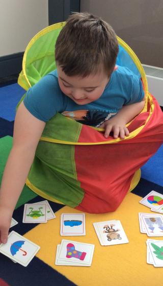 A boy playing with picture cards