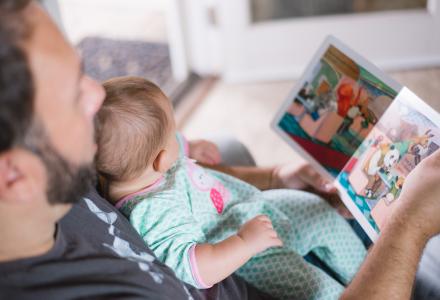 Dad reading to baby