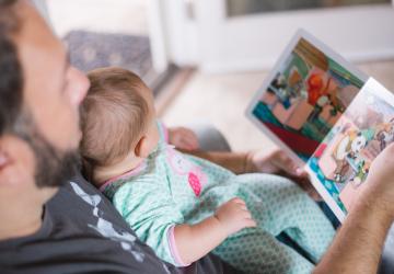 Dad reading to baby