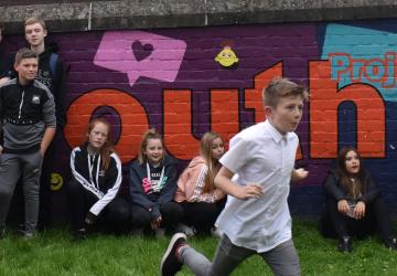 Boy running across youth centre